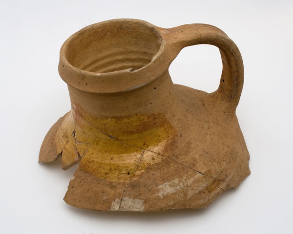 Neck of pottery jug from Andenne, yellow shard, lead glaze on the shoulder, kitchen utensils fragment soil found ceramic