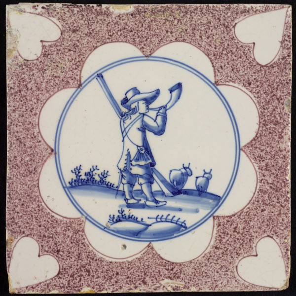 Figure tile, purple sprinkled tile, in scalloped blue circle hunter with horn and rifle, corner motif heart, wall tile