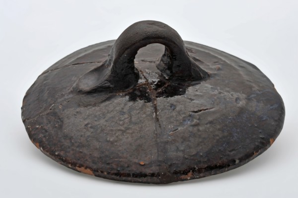 Dark brown lying around pottery lid with ear, lid closure soil found ceramic earthenware glaze lead glaze, hand-turned glazed