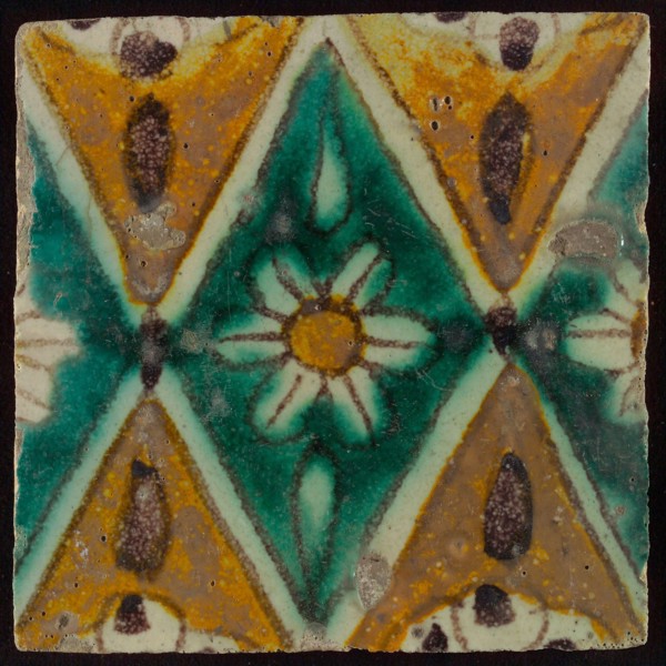 Floor tile, brown draft, green and yellow on white ground, central green oblique glass in which white flower with yellow heart