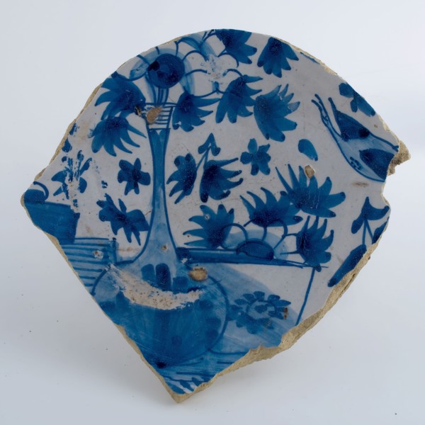Fragment majolica plate on stand, decorated with flowers in vase, in blue on white ground, plate dish crockery holder soil find
