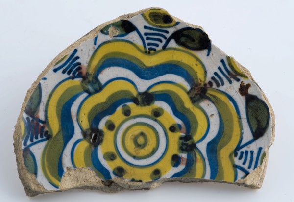 Mirror fragment of majolica dish with yellow and blue stylized flower decoration, plate dish crockery holder soil find ceramic