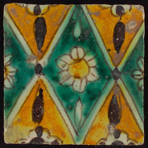 Floor tile, brown draft, green and yellow on white ground, central green oblique glass in which white flower with yellow heart