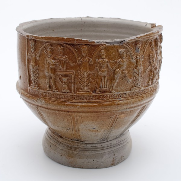Fragment of stoneware farmer's pitch with dance pairs and text under arcades, farmer's pitcher crockery holder fragment soil