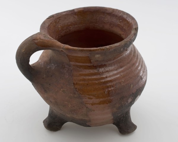 Pottery cooking jug, grape-model, red shard, sparingly glazed, sausage ear, on three legs, cooking jug