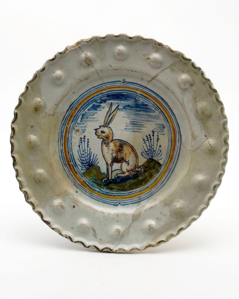 Majolica plate with seated hare, polychrome, studs in the rim, plate crockery holder soil find ceramic earthenware glaze tin