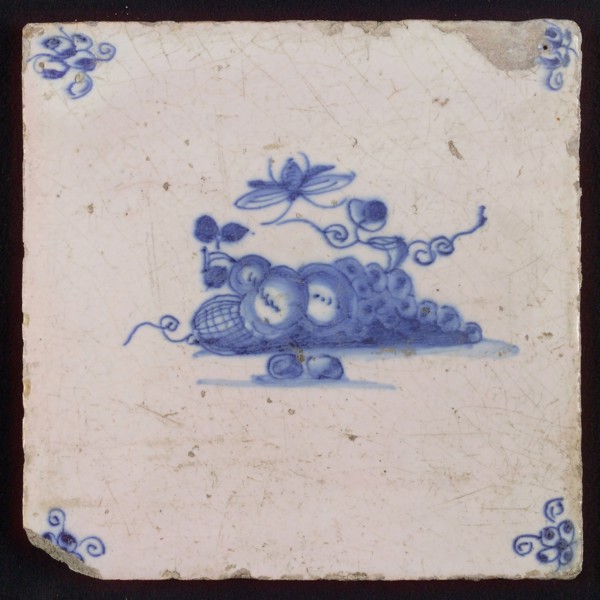 White tile with blue fruit and insect, corner motif spider, wall tile tile sculpture ceramic earthenware glaze, baked 2x glazed