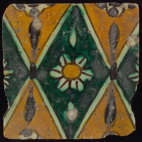 Floor tile, brown draft, green and yellow on white ground, central green oblique glass in which white flower with yellow heart