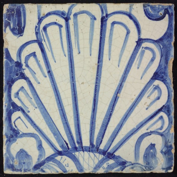 Tile of chimney pilaster, blue on white, shell-like headdress in white, chimney pilaster tile pilaster footage fragment ceramic