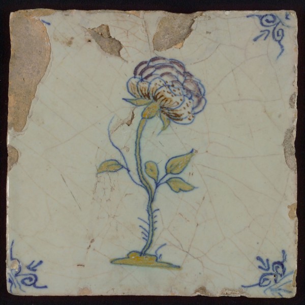 Tile, flower on spot in purple, orange, green and blue on white, corner motif oxen head, wall tile tile sculpture ceramic