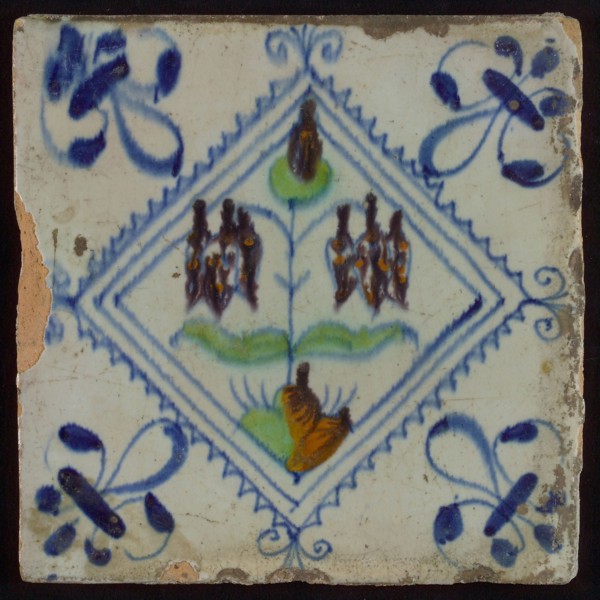 Tile, double flower on ground in brown, orange, green and blue on white, inside serrated square with plume, corner pattern