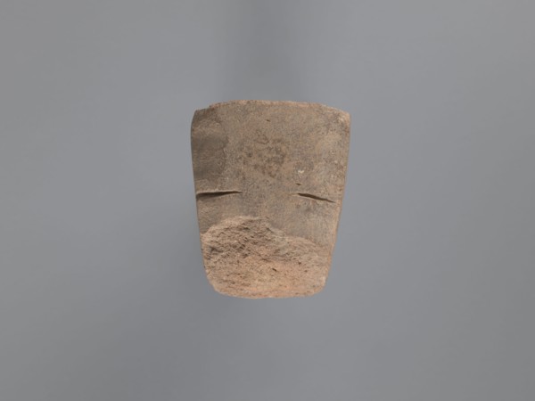 Pyramidal clay seal with a roughly square stamp surface and rounded corners. Shallow incisions at