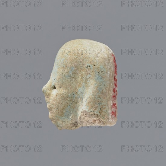 Fragment of a shabti;, Head of a shabti figurine with indistinct facial features, in a smooth wig.