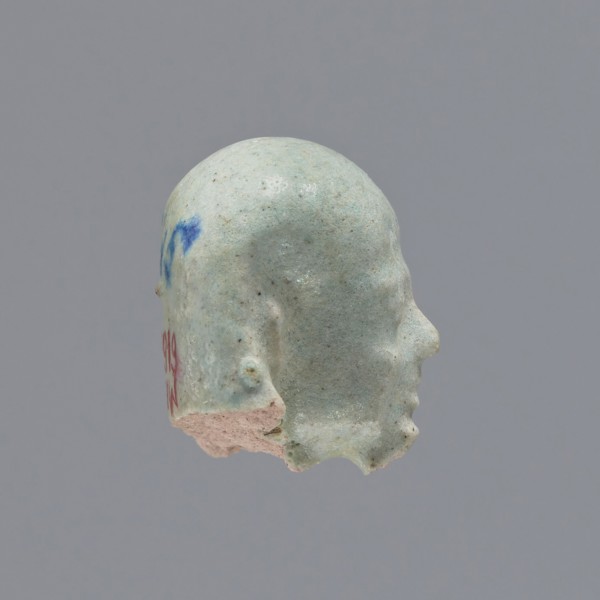 Fragment of a shabti. Head of a shabti figurine with carefully rendered facial features, in a