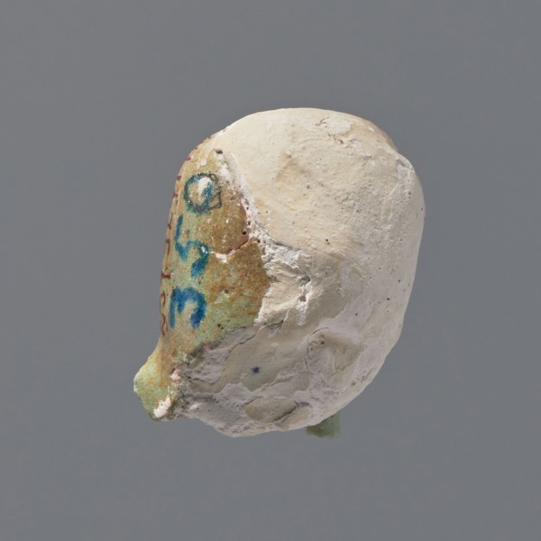 Fragment of a shabti. Head of a shabti figurine with rather carelessly rendered facial features, in