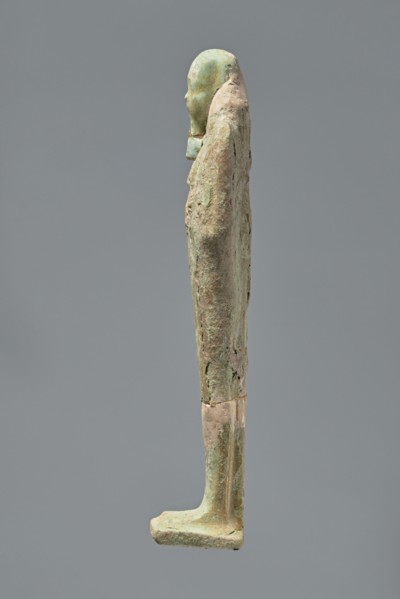 Ushabti, Mummy-shaped figurine standing on a base with the back resting on a pillar. Arms crossed