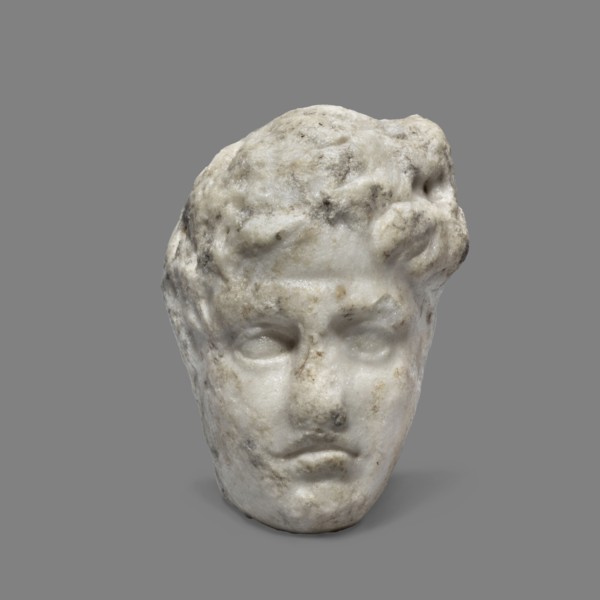 Head of a young man, unknown Greek workshop. A small head of a young man, probably a fragment of a