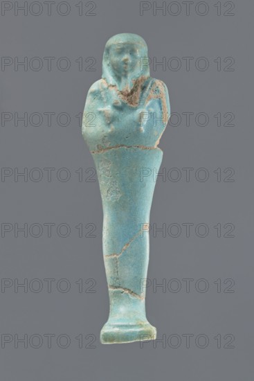 Ushabti, Mummy-shaped figurine, standing on a base with a narrow, slightly convex pillar at the