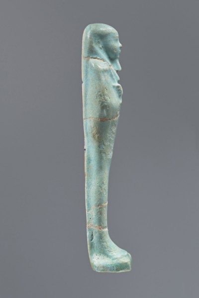 Ushabti, Mummy-shaped figurine, funerary offering, standing on a base with a narrow, slightly