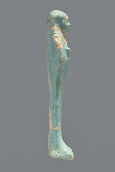 Ushabti, Mummy-shaped figurine. Standing on a base with a flat pillar at the back. Arms folded