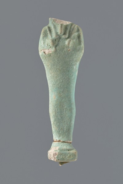 Shabti, mummy-shaped figurine, standing on a base; head missing. Narrow, slightly convex pillar at