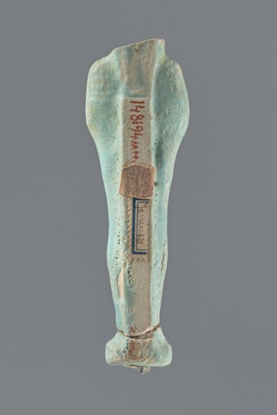 Shabti, Mummy-shaped figurine, funerary offering, standing on a base; head missing. A narrow,