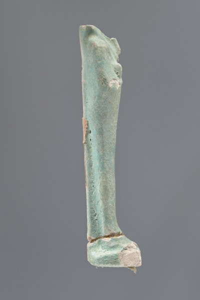 Shabti, Mummy-shaped figurine, standing on a base; head missing. A narrow, slightly convex pillar