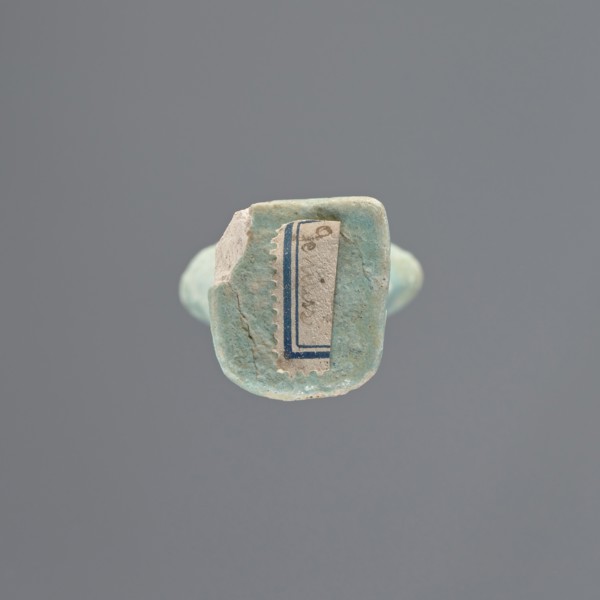 Shabti, Mummy-shaped figurine, standing on a base; head missing. A narrow, slightly convex pillar
