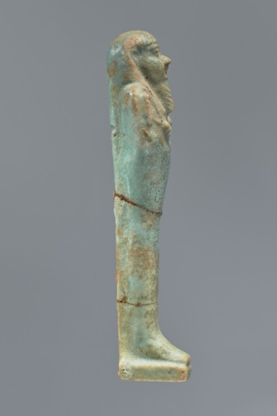 Ushabti, Mummy-shaped figurine shabti. Standing on a base with a flat pillar behind it. Arms folded
