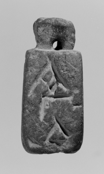 Christian amulet with Greek inscription. Limestone amulet in the shape of an elongated hexagon.