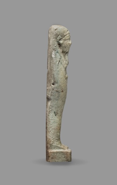 Ushabti, Mummy-shaped figurine standing on a base, back supported by a flat pillar. Arms crossed on
