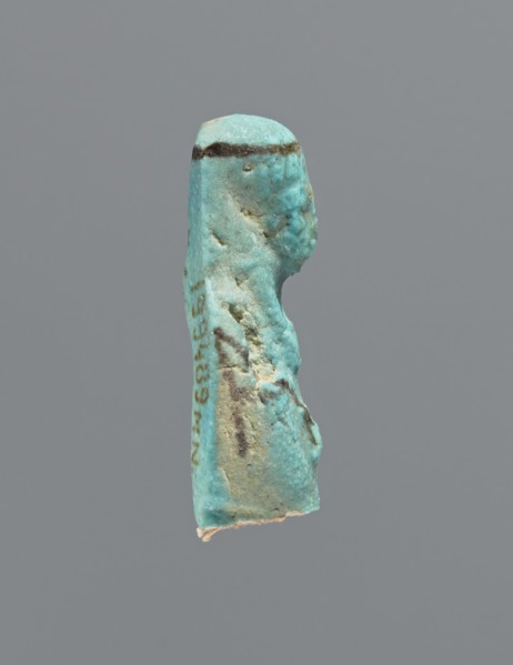 Ushabti, mummy-shaped figurine, preserved head and fragment of torso. Arms crossed on the chest,