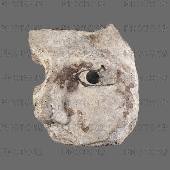 Stucco mask. Fragment of a sarcophagus mask left cheek, nose and left eye inlaid with white and