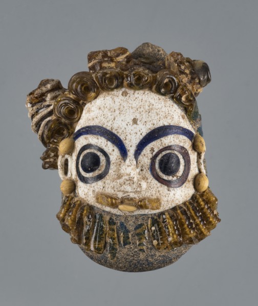 Apotropaic pendant in the shape of a male head; bearded head pendant; Carthage Tunisia; technique