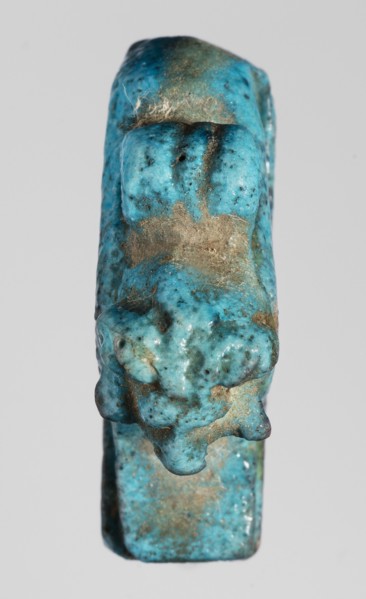 Amulet — ram. Figurine of a ram lying on a flat base, with a loop for hanging on its back. Amulet;