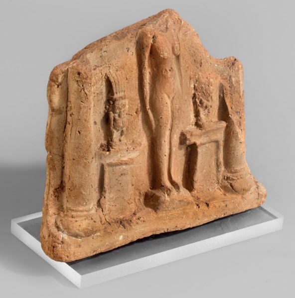 Fragment of a votive plaque in the form of a naos with the fertility goddess Isis-Hathor, and Bes;,