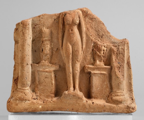Fragment of a votive plaque in the form of a naos with the fertility goddess Isis-Hathor, and Bes,