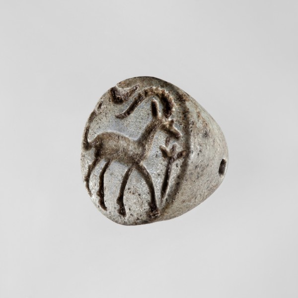 Conical stamp seal with a hole drilled below the top of the cone. On the circular base is engraved