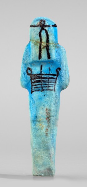 Amenhotep's shabti with baskets on the back; arms crossed on the chest, right folded over left,