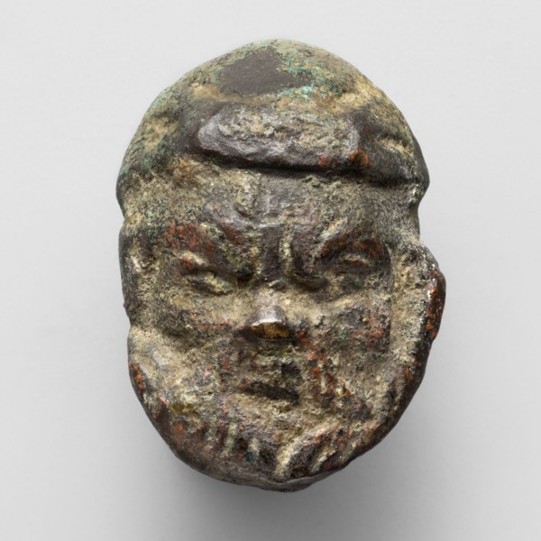 Appliqué in the shape of Silenus's head, The head of a bearded Silenus wearing a cap, designed on