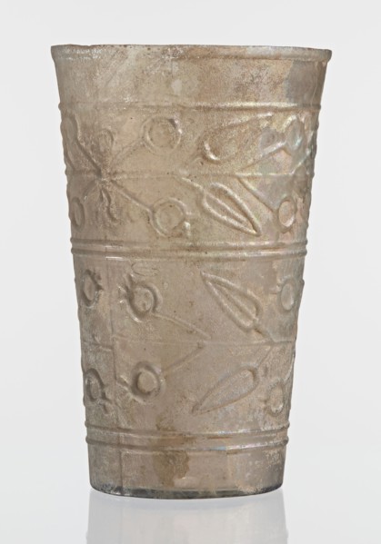 Glass decorated with a leaf and fruit motif; transparent, colorless glass with relief decoration in