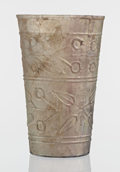 Glass decorated with a leaf and fruit motif;, transparent, colorless glass with relief decoration