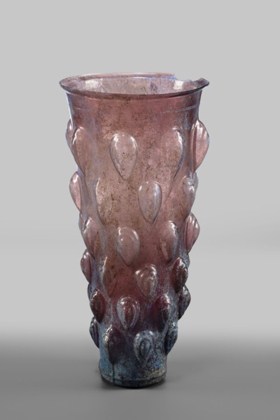 Glass mug; transparent, manganese, iridescent glass. Decorated with 6 rows of convex, stepped