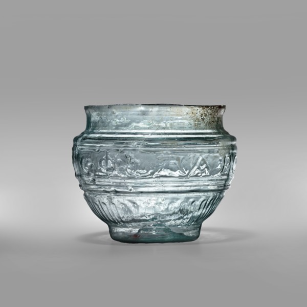 Bowl with Greek inscription. Glass bowl made of transparent, light blue glass with a Greek