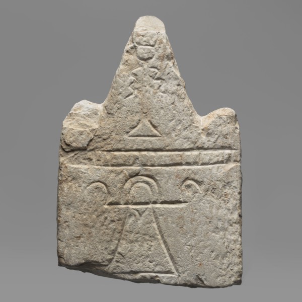 Votive stele with the sign Tanit, unknown Carthaginian workshop. Upper part of a stele with