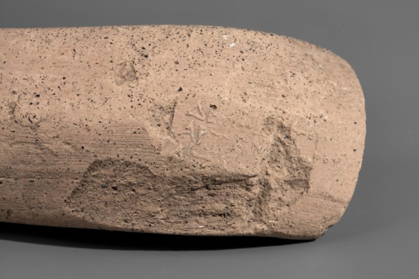 Fragment of a Sinopean amphora vice with a partially preserved rectangular stamp. The stamp is oval