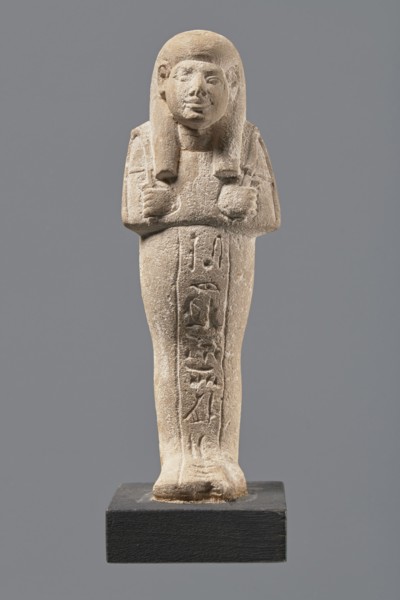 Ushabti, Mummy-shaped figurine made of limestone. Arms crossed on the chest, right folded over