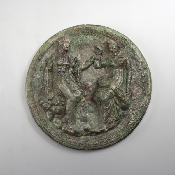 Mirror cover with an image of a couple. The bronze cover is decorated with a figurative scene of