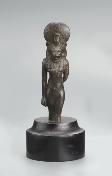 Sekhmet figurine, lion-headed goddess shown standing or walking. The figure has a lioness' head in