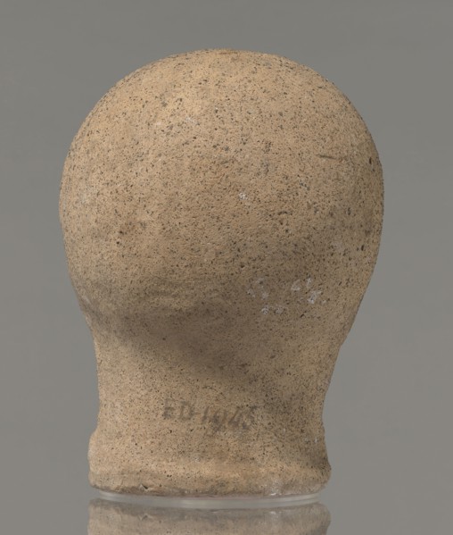 Votive head, unknown creator, Head of a young man covered with a shawl, from under which hair